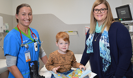 Dr Kate Bradman (PCH ED Consultant) holding a CAM Boot, Leo and Jodie Bowles in PCH ED