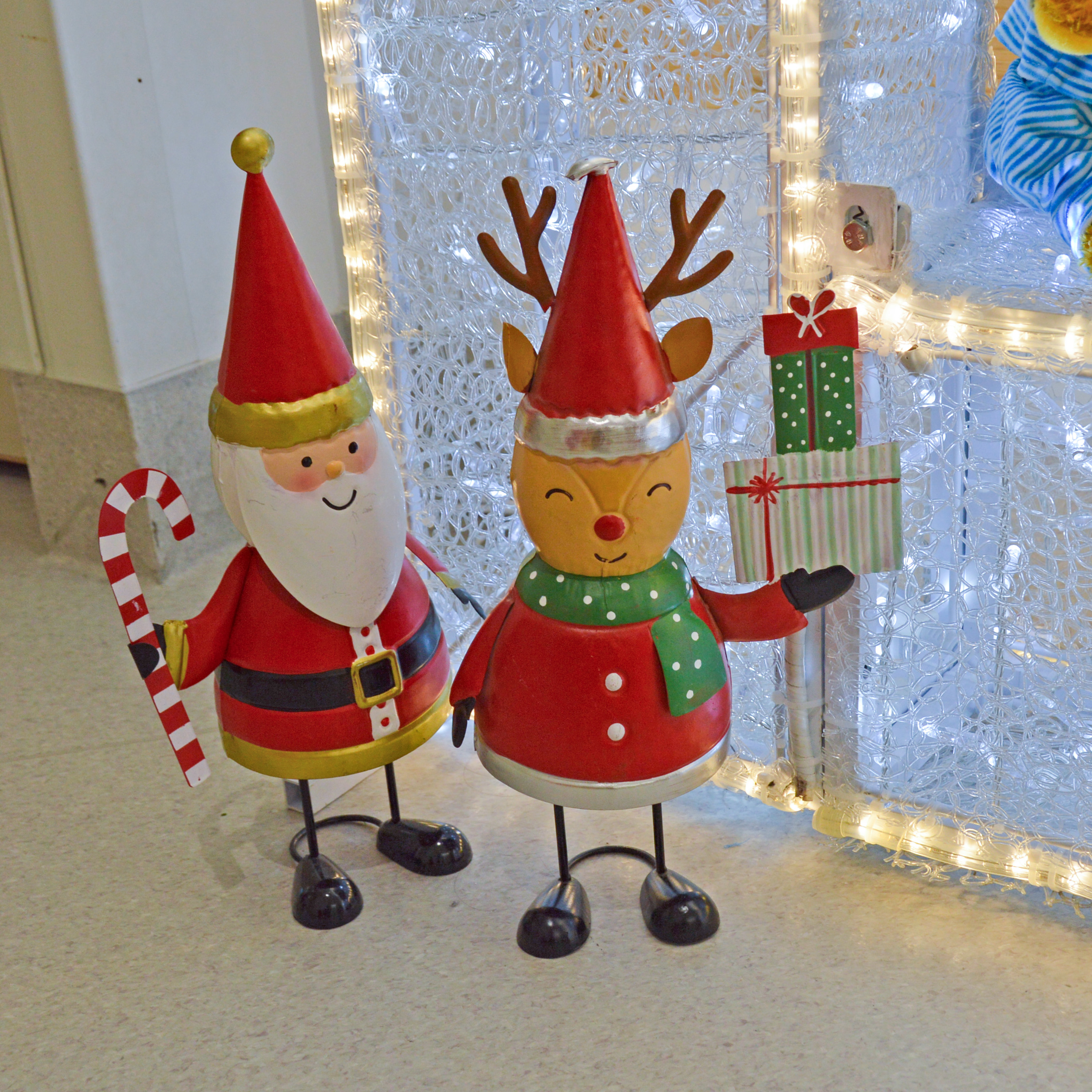 Christmas decoration in Perth Children's Hospital, a Santa figurine stands next to a reindeer statue