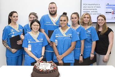 EN Early Practitioner Program graduates for 2018 gathered around a cake