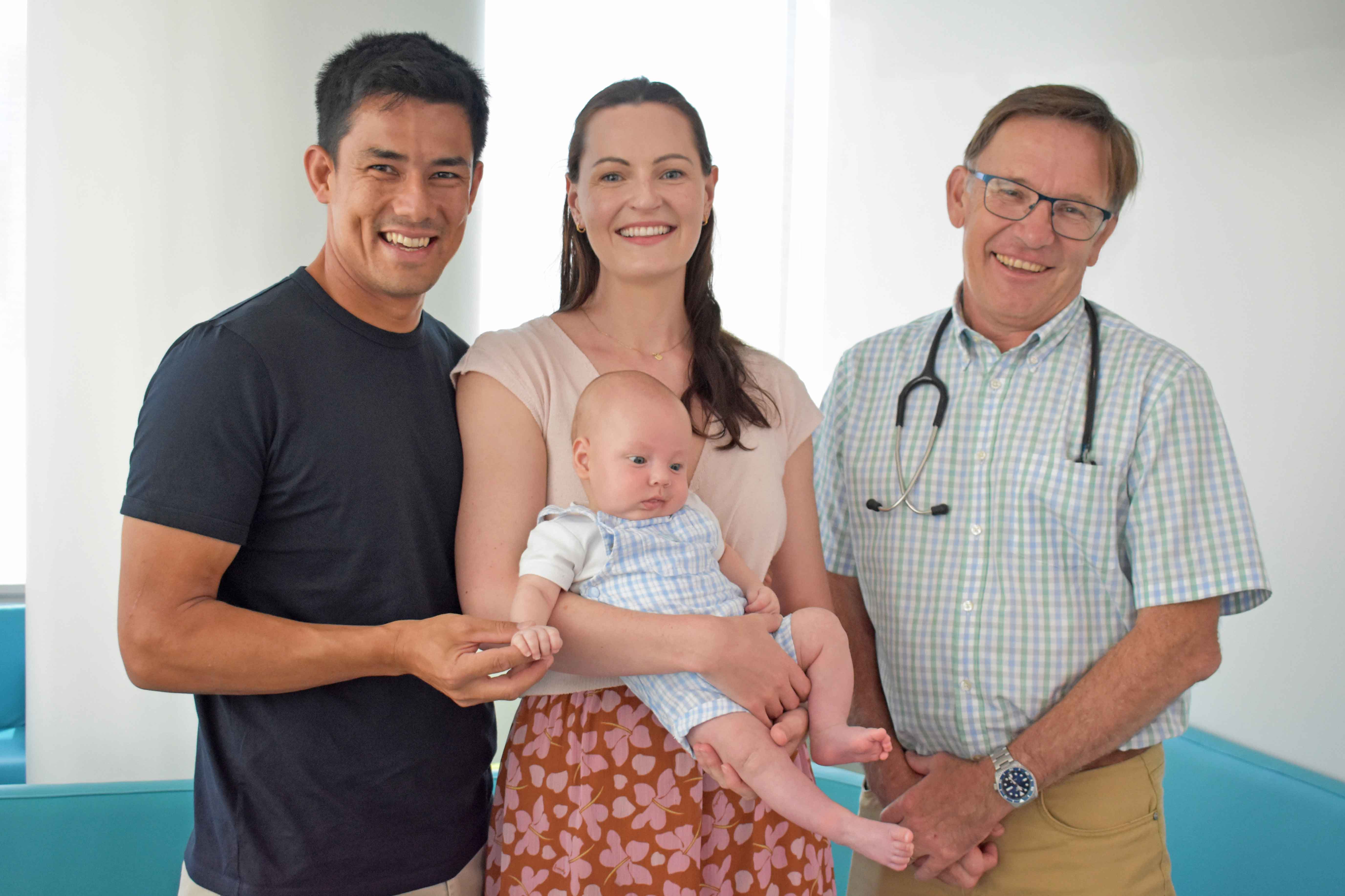 Baby Eric is pictured with his parents and Professor Peter Richmond.