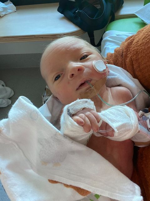 Baby Max being held in hospital
