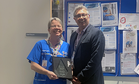 Vicky Burke with Stars of CAHS Award, standing next to CAHS CE, Aresh Anwar 