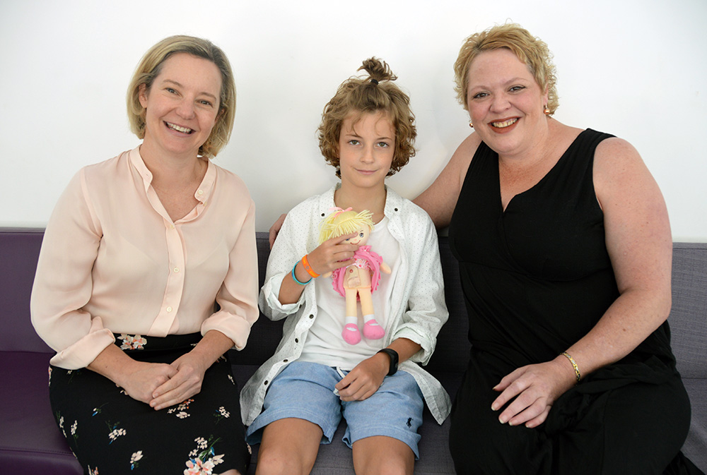 Katie McKenzie (ED of Nursing), Max and Kelly Moss with a stoma doll