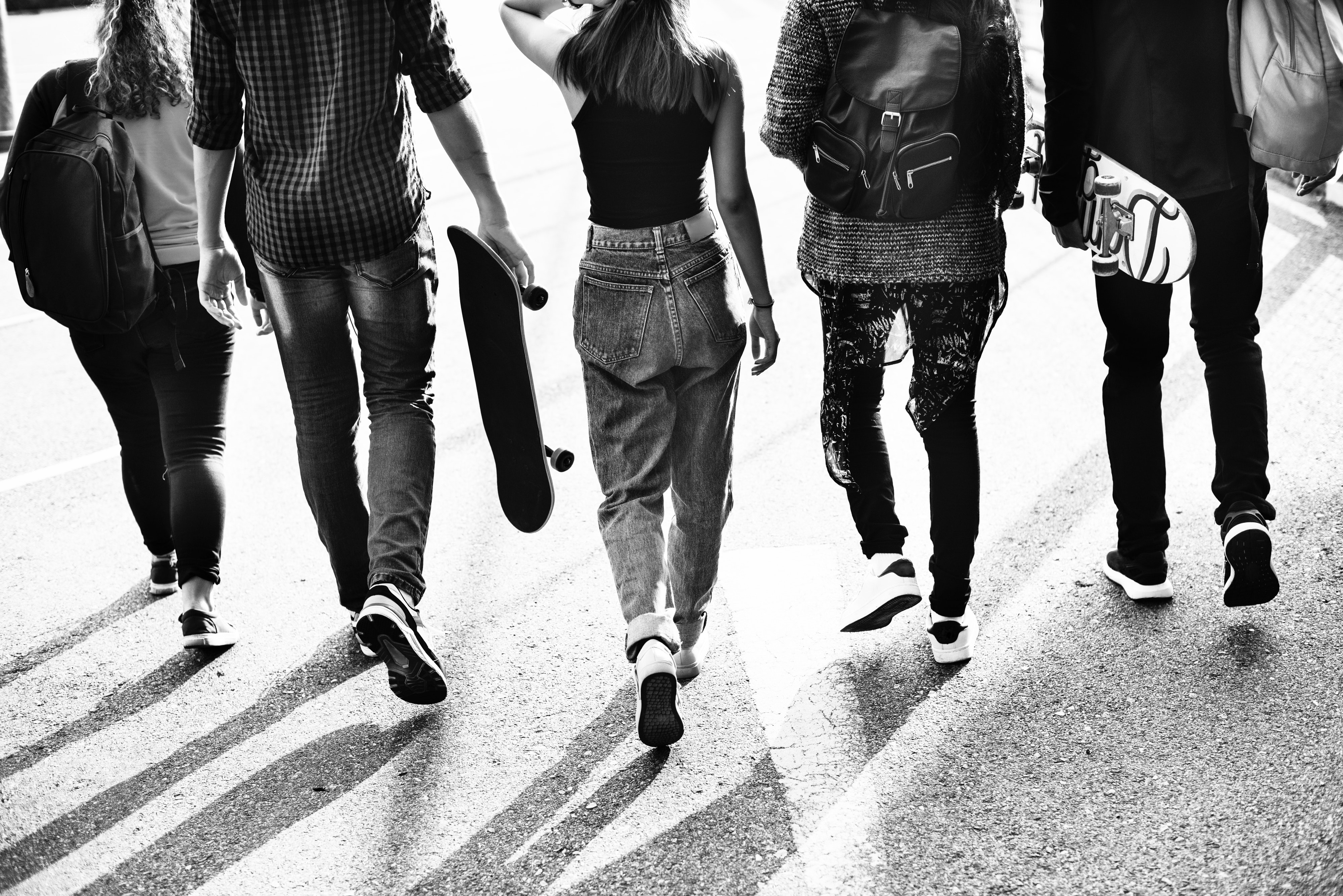 Teenagers walking, with skateboard