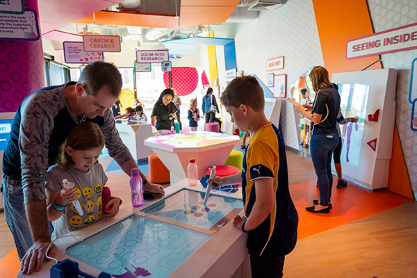 Dad and kids inside at Telethon Kids Discovery Centre