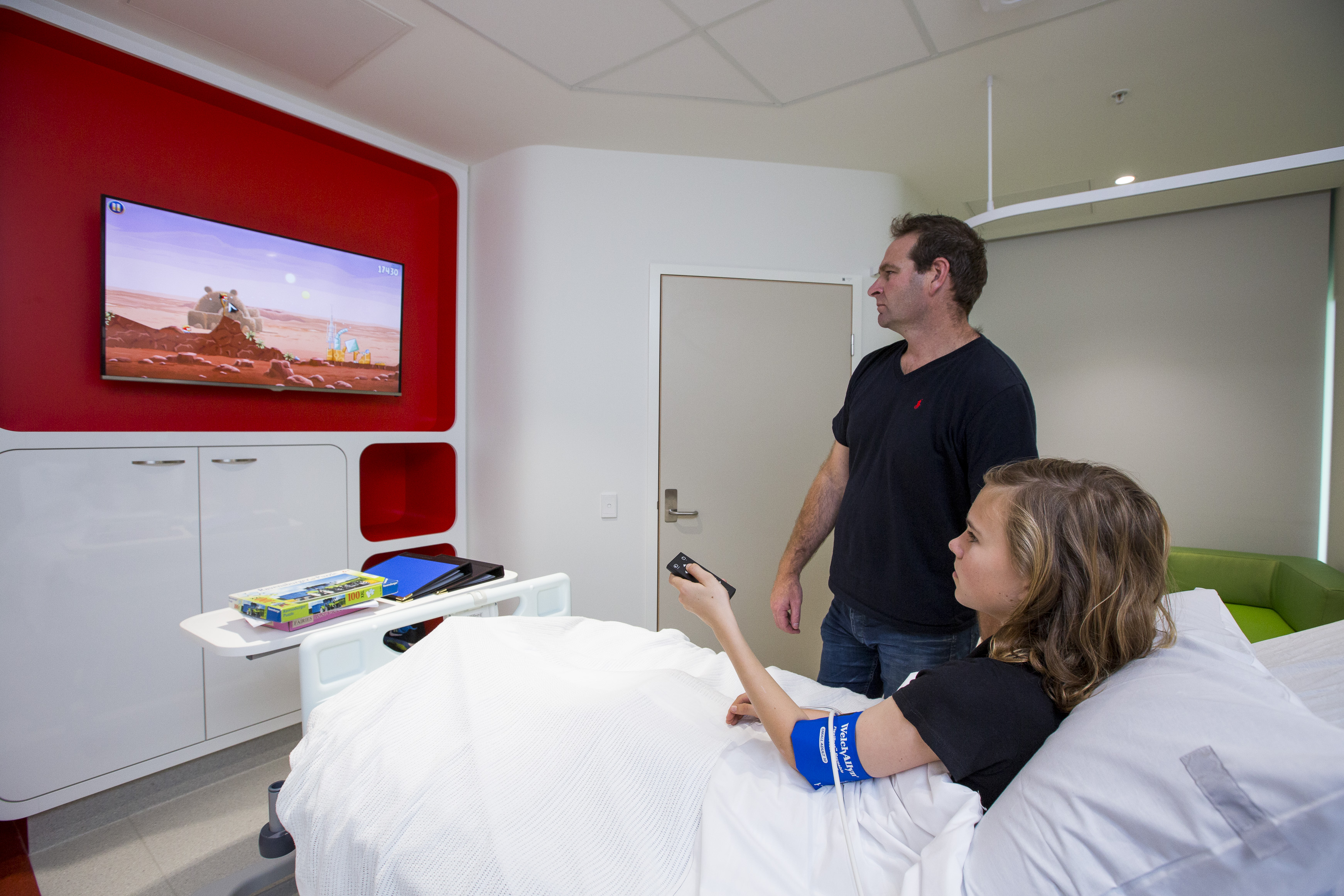 Father and son using the Patient Entertainment System at the bedside in PCH